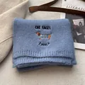 Macro detail of blue knit scarf featuring cute dachshund embroidery and soft wool texture - Light Blue