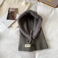Detail of grey knitted balaclava with warm faux shearling lining and button closure - Gray