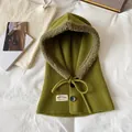 Close-up of green knit balaclava showing warm fleece lining and button details - Green