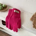 Detail of rose pink knit gloves with ribbed cuffs and original woven brand labels - Rose Red