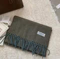 Detail of wool fringe scarf texture with brand label and tags on soft knit surface - 180x30cm / Army Green
