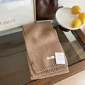 Detailed close-up of brown 100% wool knitted scarf showing cozy tweed texture and rib trim - Coffee
