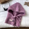 Purple knitted balaclava with drawstring and button on soft white background - Pink Purple