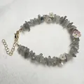 Detail of natural grey labradorite stone bracelet with white acrylic flower charms - Labradorite