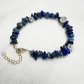 Macro detail of natural blue stone beads and small white flower accents on bracelet - Lapis Lazuli