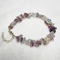 Macro view of crystal beaded bracelet with amethyst gravel and floral charms - Fluorite