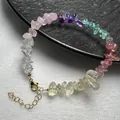 Detailed macro view of handmade rainbow crystal chip bracelet with golden lobster clasp - Bracelet Style