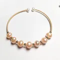 Detail of 14K gold-filled wire bracelet featuring pink pearls and white pearl tips - Pink Pearl