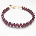 Detail of garnet beaded bracelet with 14K gold filled wire wrap and lobster clasp - Garnet Bracelet
