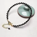 Detail of garnet beaded bracelet with gold plated wire wrap and lobster clasp - Black Spinel Bracelet