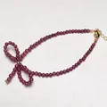 Elegant deep red garnet beaded necklace with gold bow charm and adjustable lobster clasp - Bracelet Style