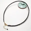 Macro shot of faceted black spinel beads with adjustable 14K gold-plated lobster clasp - Black Spinel Necklace