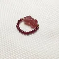Detail of garnet beaded ring featuring a translucent carved strawberry crystal Pixiu charm - Garnet / Garnet Style 1