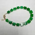 Detailed macro of green clover beads with gold spacers and 14K gold lobster clasp - Swastika Style / Green