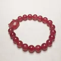 Close-up of strawberry quartz beaded bracelet featuring a cute cat-shaped charm and gold accents - Large Beads Bracelet Style