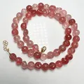 Macro detail of a natural strawberry quartz beaded necklace with adjustable gold clasp - Strawberry Quartz