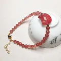 Translucent strawberry quartz beaded bracelet with pink carved cat head and gold clasp - Small Beads Bracelet Style