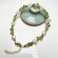 Close-up of baroque pearl bracelet with green peridot gravel and adjustable gold clasp - Peridot and Baroque Freshwater Pearl