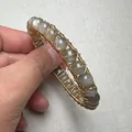 Macro shot of 14K gold wire wrapping technique on sunstone crystal beaded bracelet - Gold Wire Frame Gray Bead Style (Style 9)