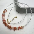 Macro shot of S925 sterling silver lobster clasp and orange sunstone beads on the necklace - Arusha Stone