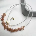 Macro shot of 925 silver clasp and heart charm on handmade beaded crystal necklace - Sunstone