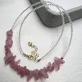 Macro detail of strawberry crystal beads with gold lobster clasp and 925 silver tag - Madagascar Rose Quartz