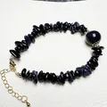 Macro shot of blue sandstone chip bracelet with gold adjustable clasp and main bead - Blue Sandstone