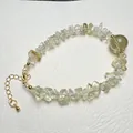 Detail of yellow natural crystal stone bracelet with gold plated clasp and extender chain - Citrine