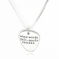 Macro detail of silver guitar pick necklace with when words fail music speaks engraving - Silver Guitar Pick Style (A1307)