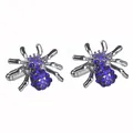 Macro detail of silver spider cufflinks with dark blue crystal pavé embellishments - Blue