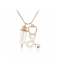Golden stethoscope and syringe necklace with white enamel detail on white background - Gold Stethoscope and Syringe Style (A1762)