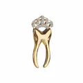 Macro detail of tooth-shaped brooch with golden crown and sparkling rhinestones - Gold