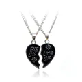Close-up of split heart puzzle pendants engraved with Big Sis and Little Sis text - Black