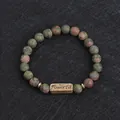 Unakite natural stone beaded bracelet with bronze Powerful engraving on black texture - Unakite (Powerful)