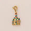 Detailed view of a golden castle pendant with pink and cyan enamel for bags and jewelry - Castle