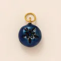 Macro view of blueberry shaped charm with blue enamel and 18K gold plated loop - Blueberry