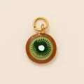 Macro shot of a 18K gold plated kiwi fruit slice pendant with green enamel detail - Kiwi