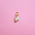Macro detail of gold-plated ice cream pendant with white enamel and lobster clasp - Ice Cream Ornament