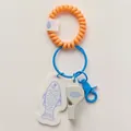 Close-up view of a cute fish and whistle bag charm featuring an orange spiral wristlet - Little Fish Whistle Charm