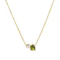 Detailed macro view of gold necklace with white pearl and green pear-cut zircon pendant - August