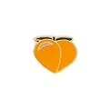 Detailed view of an orange peach enamel pin with green leaves and a golden metal finish - Peach Style