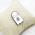 Close-up of cute white ghost enamel pin with yellow flowers on woven display pillow - Ghost Holding Flowers Style (XZ0976)