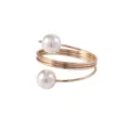 Elegant gold spiral napkin ring featuring triple-layer metal loops and two white pearls - Gold