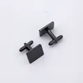 Detailed view of two polished black square cufflinks with classic T-bar swivel closures - Rectangular Black