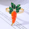 Golden carrot napkin ring with vibrant orange enamel and green leaf detail for Easter table decor - Carrot Napkin Ring