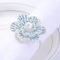 Elegant floral napkin ring with blue rhinestones and pearl on white linen napkin - Light Blue Rhinestone