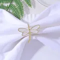 Elegant gold dragonfly napkin ring with white enamel wings on a folded white napkin - Cream White (Z1059-1)