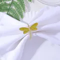 Detailed close-up of a golden dragonfly napkin ring with yellow enamel wings on white cloth - Mustard Yellow (Z1059-5)