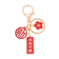 Traditionele Chinese sleutelhanger met rode Fu bedel en gouden Future Awaits hanger - Veelbelovende toekomst