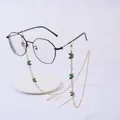 Detail of beaded glasses chain with gold links, white pearls and green enamel butterfly - Butterfly Green